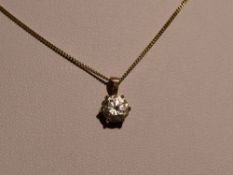 A cubic zirconia solitaire pendant in a claw set 9ct gold mount on a 9ct gold chain, approx 18' with