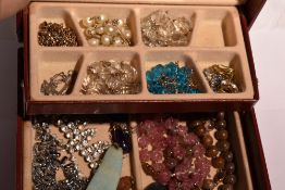 A small jewellery box containing vintage costume jewellery necklaces, polished mineral pendant,