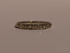 An American Orange Blossom white metal band ring stamped 18k by TRAUB having four inset diamond