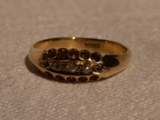 A lady's dress ring having five small old cut diamonds in a pave set boat mount on a yellow metal