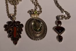 Three silver pendants of Artisan style having garnet, coral and green/red paste stone decoration