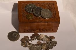 A silver charm bracelet having 33 threepenny piece charms and a padlock clasp, in a small wooden box