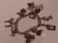 A silver charm bracelet with padlock clasp having eight white metal charms including camel, emu,