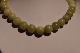 A string of Jadeite style beads of large even form, diameter approx 12mm, approx 16' & 119g