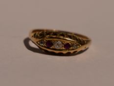 A lady's dress ring having two rubies interspersed by three diamond chips in a gallery mount on a