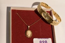 A conch shell cameo pendant depicting a maiden in profile in a 9ct gold mount with chain, and a