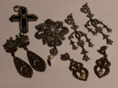 A silver pendant/brooch having marcasite and seed pearl decoration with matched similar earrings,