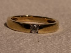 A lady's dress ring having a tension set cubic zirconia in a 14ct gold band, size M &approx 2.7g