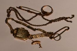 A 9ct gold wrist watch by Emka having an Arabic numeral dial to square face on a rolled gold