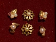 Three pairs of 9ct gold and yellow metal stud earrings having seed pearl decoration, approx 1.9g