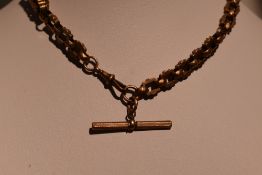 A Victorian rolled gold fancy link watch chain of chunky form having dog leash clasp and T bar