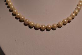 A string of cultured pearls having a 9ct gold decorative box clasp, approx 25' (AF)