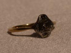 A lady's dress ring having a five stone diamond cushion cluster in a pave set mount on a yellow