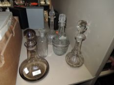 A selection of clear cut and antique glass decanters including Caithness Scotland