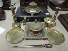 A selection of desktop items including brass cast ink well and leather bound carry case