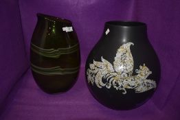 A large piece of statement glass in green and a large vase.