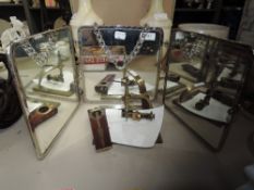 A small portable vintage dressing table top mirror with chain to hang on wall having birds to