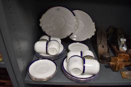 A collection of Tuscan cups and saucers,side plates and cake plates, having white ground with blue