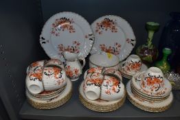 An antique part coffee service having orange and black floral pattern with gilt detailing includes
