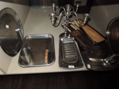 A lot containing a selection of stainless steel trays, toast rack,serving platters and vintage