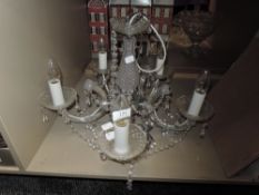 A ceiling light in the form of a chandelier, having Five bulbs.