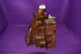 A abstract piece of glazed terracotta pottery, in the style of a cluster of buildings.