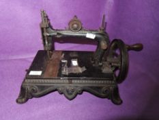 A Victorian crank handled Thomas Mcgrah Triumph sewing machine.