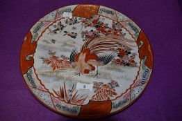 A decorative early 20th century Japanese plate in russet tones depicting cockerel, flowers and