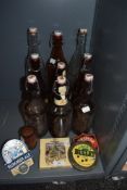 A selection of breweriana interest items including bottles and pump mounted beer advertising