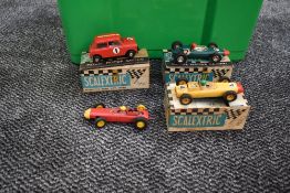 Four Triang Scalextric Slot Racing Cars, BRM C/72 in green, Mini Cooper C76 in red, Porsche C73 in