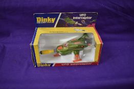 A Dinky diecast, UFO Interceptor, with rocket, on polystyrene stand in window display box 351