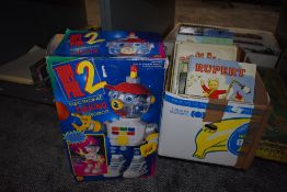 A box containing 10 Daily Express Rupert Annuals, two Dandy Beano Books and a folder of black and