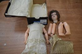 A early 20th century Simon & Halbig bisque headed doll having sleep eyes, open mouth with four teeth