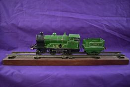 A Bing/Hornby style repainted clockwork 0 gauge 2-4-0 LNR Loco & Tender 5603, on wooden display