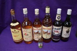 Three One Litre bottles of Whisky, Bells, High Commissioner and Famous Grouse, a 70cl bottle of