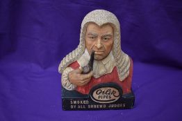 An Advertising Bust of a Judge Smoking Pipe for Orlik Pipes, Smoked By All Shrewd Judges, by Legend