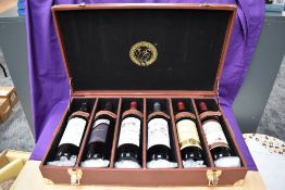 A leather effect Le Grand Amateur Du Vin six bottle case containing six bottles of wine, 2004