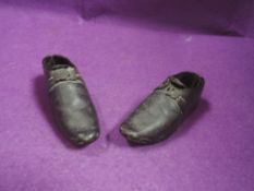 A pair of antique leather and wood childrens clogs/shoes.