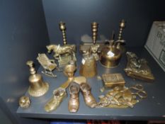 A selection of brass fire side items including candle sticks and terrier dog door knocker