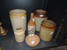 Six items of glazed earthen ware including an advertising bottle of local interest for Alexanders'