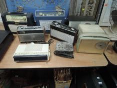 A selection of vintage transistor radios including Hacker Roberts and Hitachi alarm clock