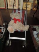 A vintage childrens Play buggy and teddy bear