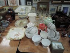 A mixture of ceramics and kitchen ware including cheese dome., coasters, cups and saucers and more.