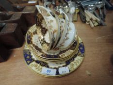 A selection of antique tea cups and saucers with cobolt gold and cream glaze