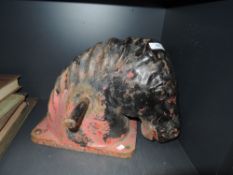 A mid century cast iron horses head from a childrens playground rocking horse having charming age