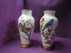 Two large Franklin porcelain vases with stands having birds,flowers and berries to fronts.