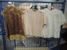 Three vintage 1950s blouses, different styles and sizes.