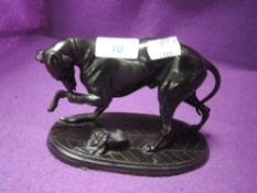 A vintage spelter figure of a greyhound nursing a poorly leg.
