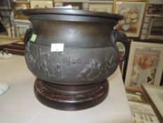 an early 20th century Chinese export cache pot or planter having raised reliefe of village scenes