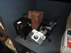 A vintage box camera, a Kodak instamatic 25 and a Velbon tripod.